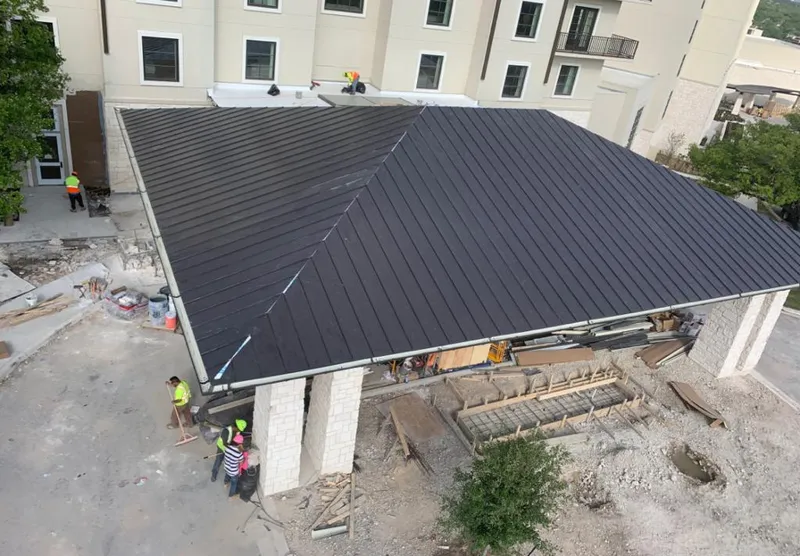 Metal roofing installation team working on a commercial building in Powell
